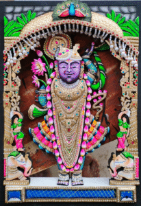 Shrinathji Rajbhog gold-leaf wooden painting with gold leaf, gemstones, and ornate decorative frame.