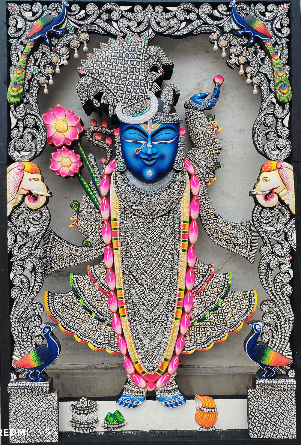 Shrinathji Rajbhog silver gemstone wooden painting with peacocks, lotus flowers, and ornate carved frame.